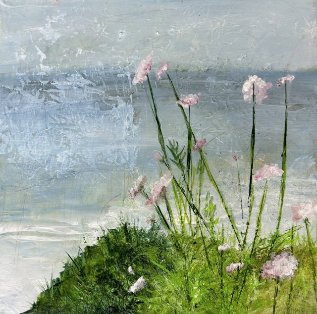 An acrylic painting of a seascape as seen from a hilltop with green grass and tall stemmed pink flowers in the foreground by Juanita Bellavance