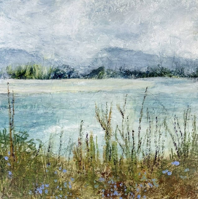 An acrylic painting of a scene of a lake with mountains in the distance and tall reeds in the foreground on the shore with small purple flowers. By Juanita Bellavance